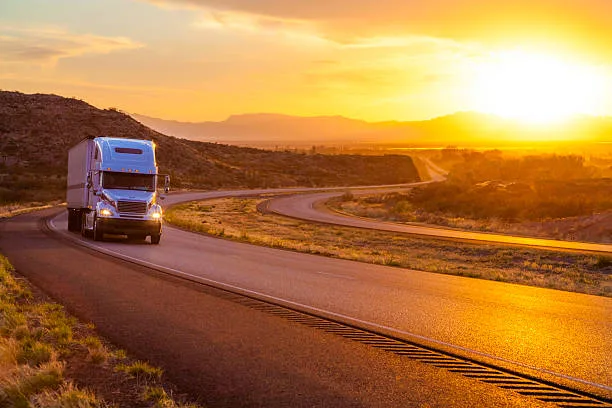Semi truck on I-80 highway near Laramie Wyoming at sunset - mobile diesel repair service area